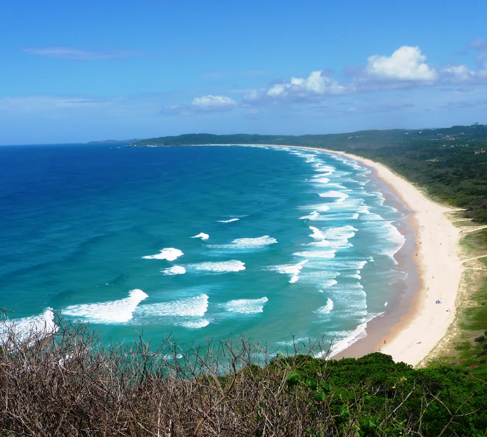 Sunshine over the sweep of Tallow Beach at Byron Bay